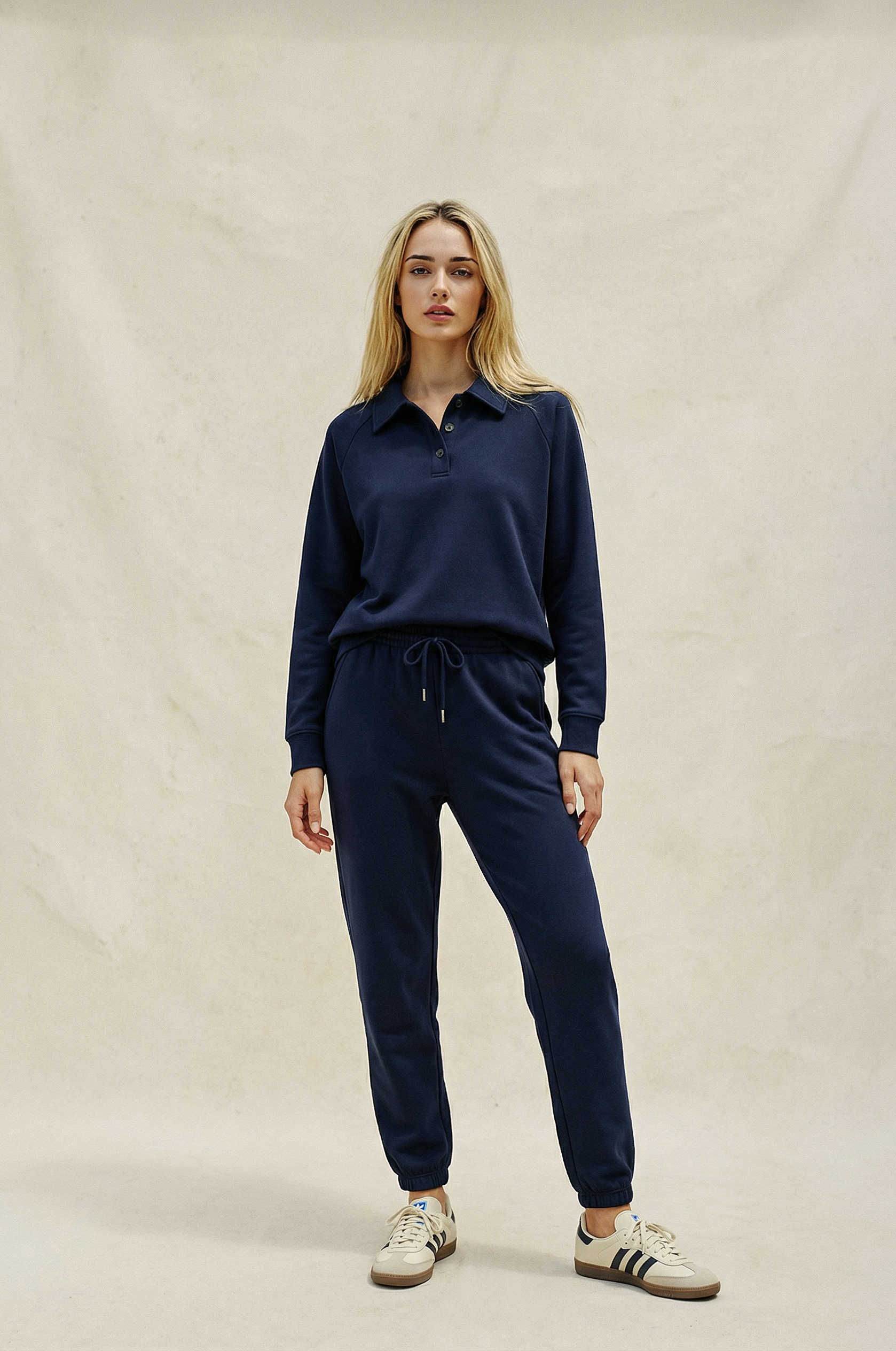 Woman wearing a navy blue outfit on a beige background
