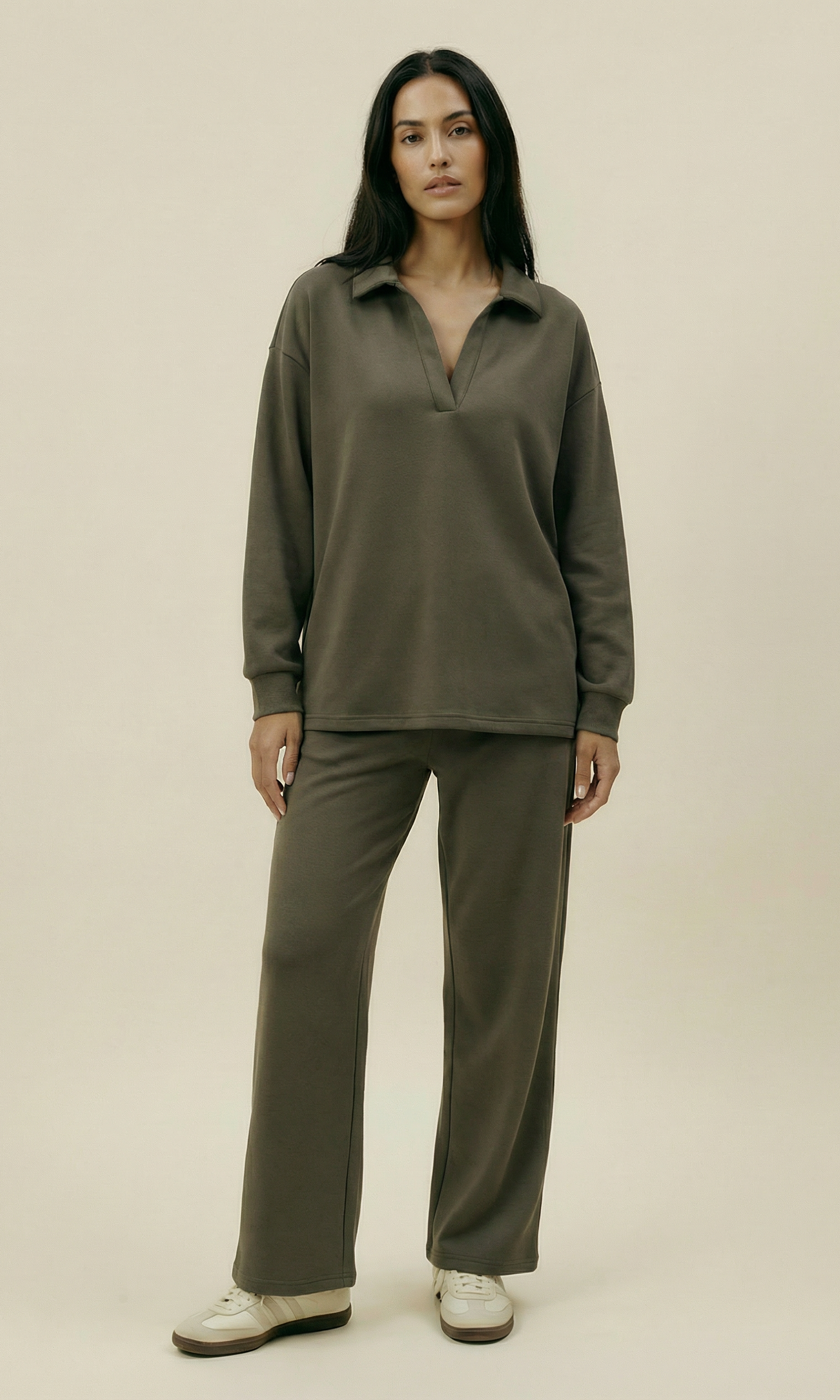 Woman wearing a green outfit on a beige background