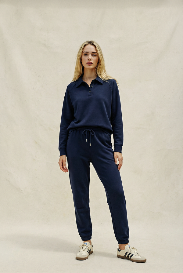 Woman wearing a navy blue outfit on a beige background