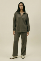 Woman wearing a green outfit on a beige background